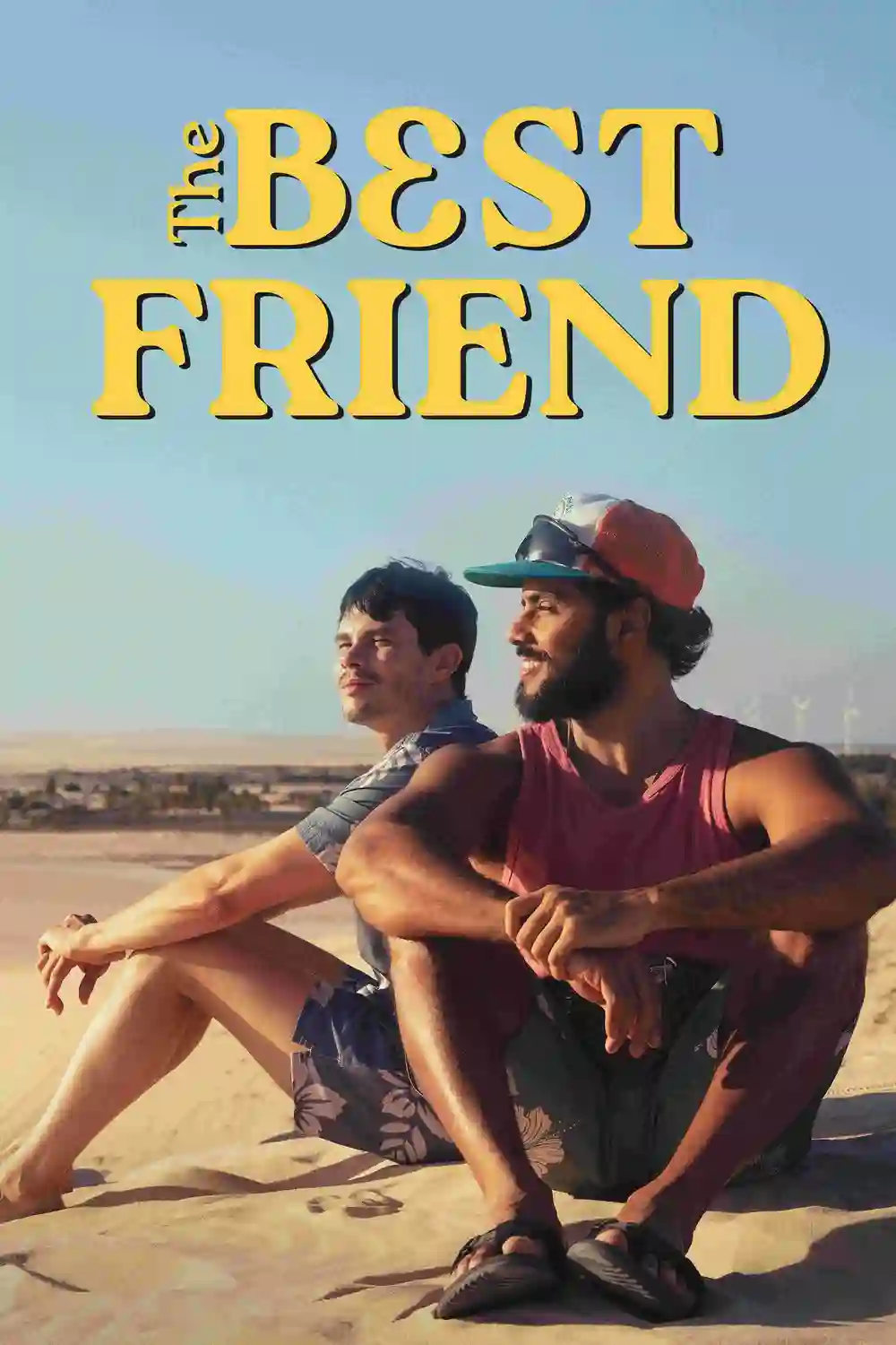 The Best Friend poster shows two close friends relaxing on sand dunes in a heartfelt gay romance about friendship becoming love.