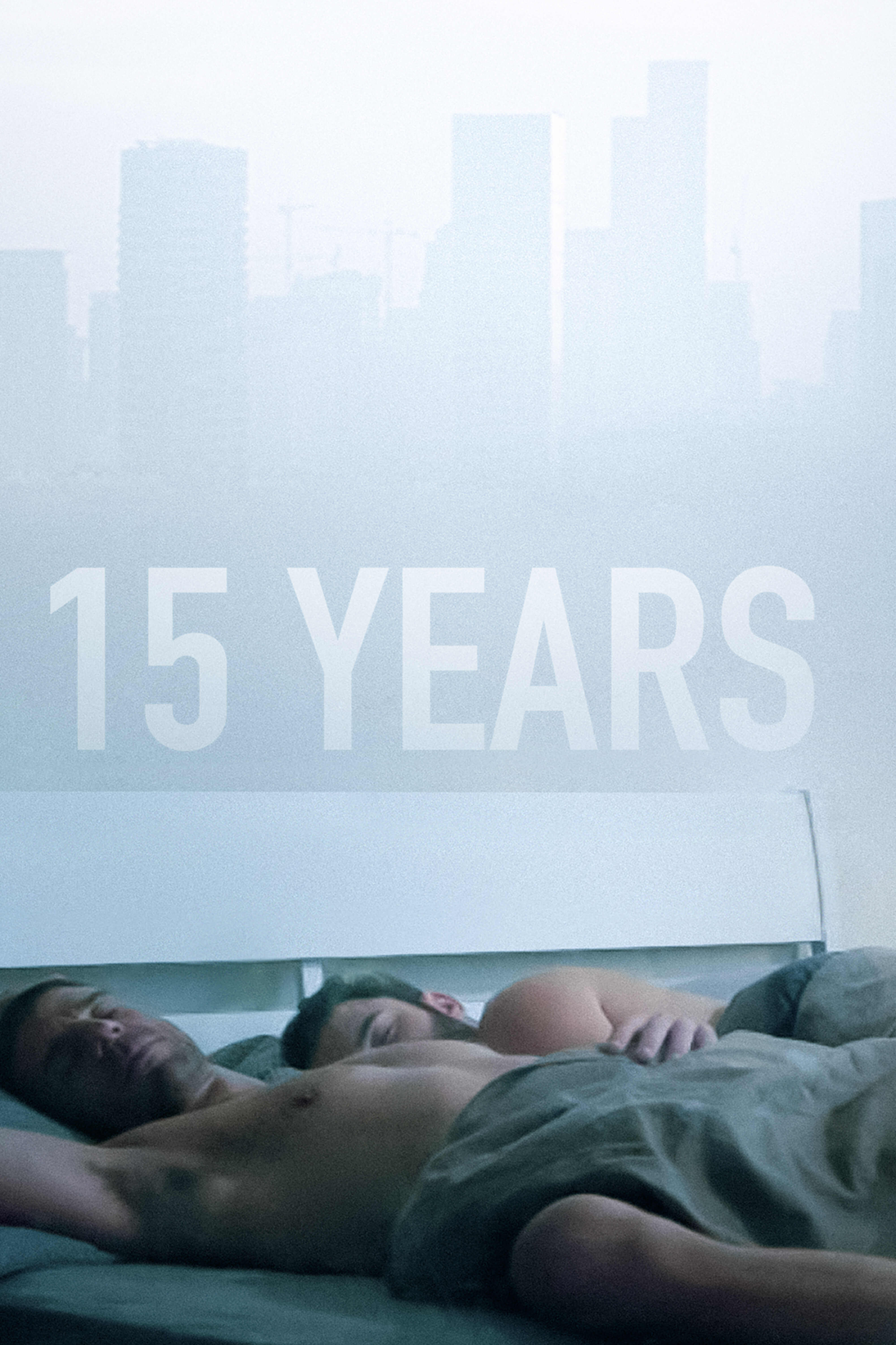 Two men lying together in bed beneath the title “15 Years,” with a hazy city skyline visible through the window behind them.