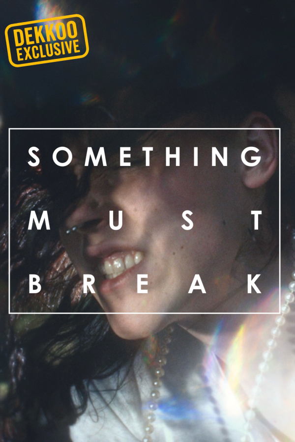 Something Must Break movie poster featuring a smiling young person, a Dekkoo Exclusive film.