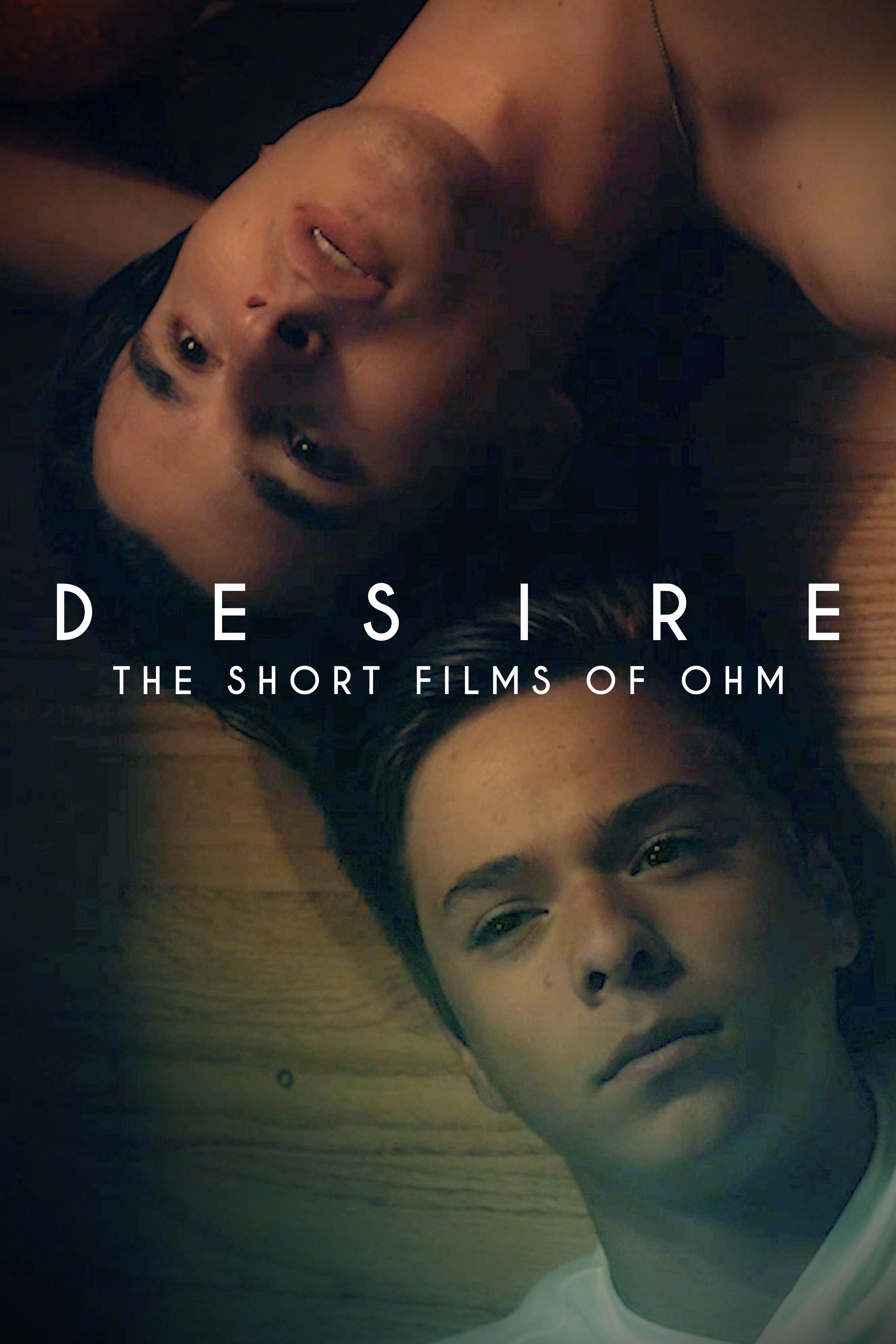 Desire: The Short Films of Ohm cover art featuring two men lying together, their faces shown in a dark, intimate composition.