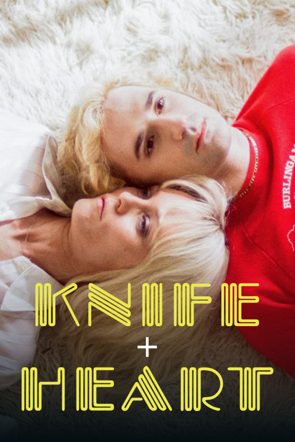 Knife + Heart movie poster featuring two blond men lying together, with the film title in yellow lettering.