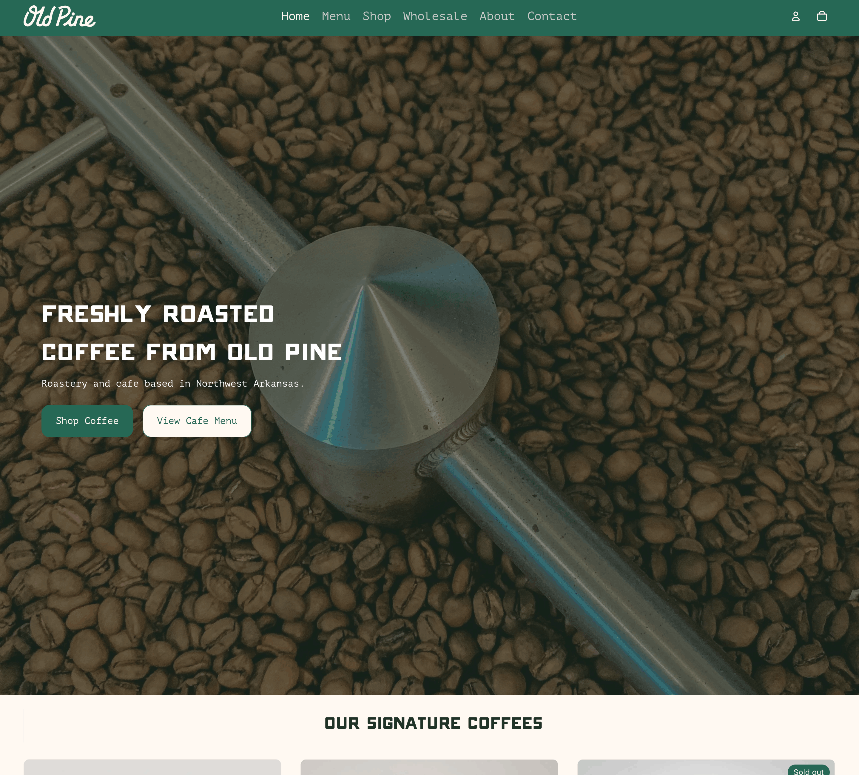 Metal arm stirring freshly roasted coffee beans in a roasting machine with an overlay text about Old Pine coffee.