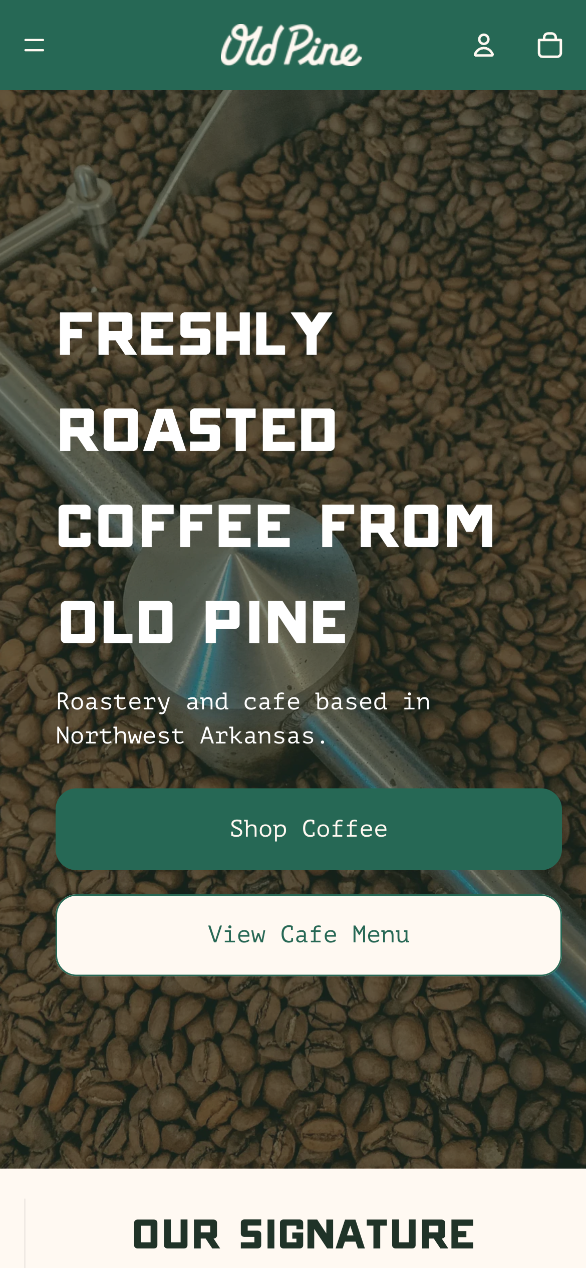 Background of roasted coffee beans with text promoting freshly roasted coffee from Old Pine, a roastery and cafe in Northwest Arkansas, with buttons to shop coffee and view cafe menu.