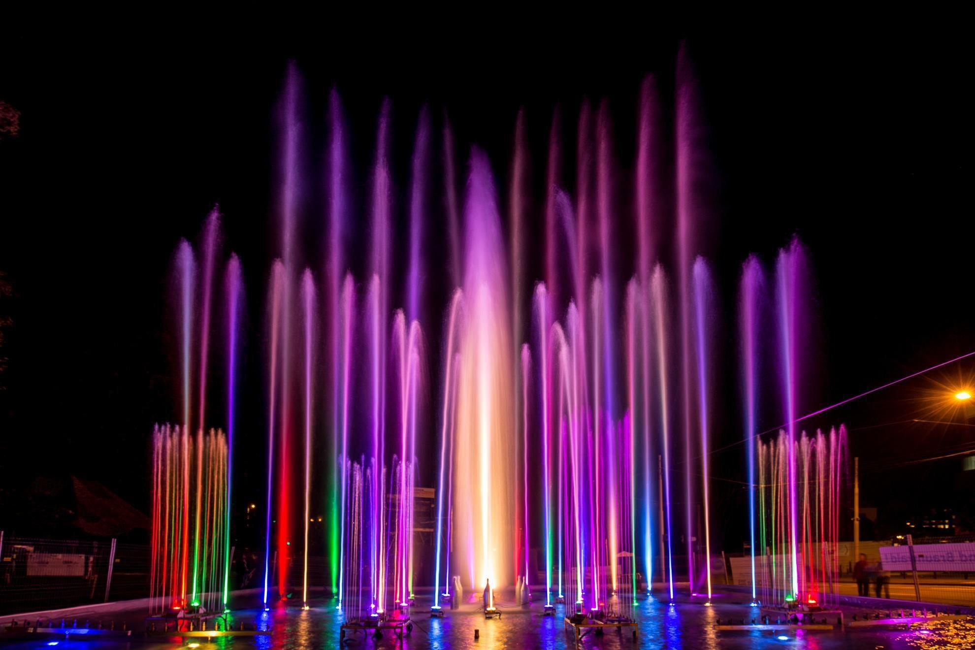 Farbig beleuchtete Wasserfontänen bei Nacht