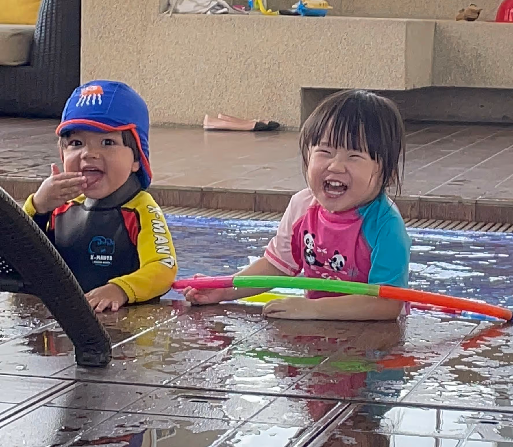 Giggling babies during gentle playful water activities with parents in Singapore