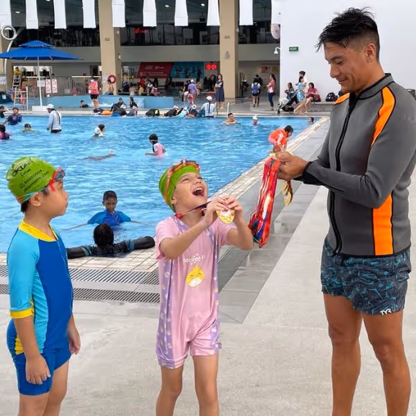 Happy student with Coach Sean during swimming lessons at Swim Class Singapore