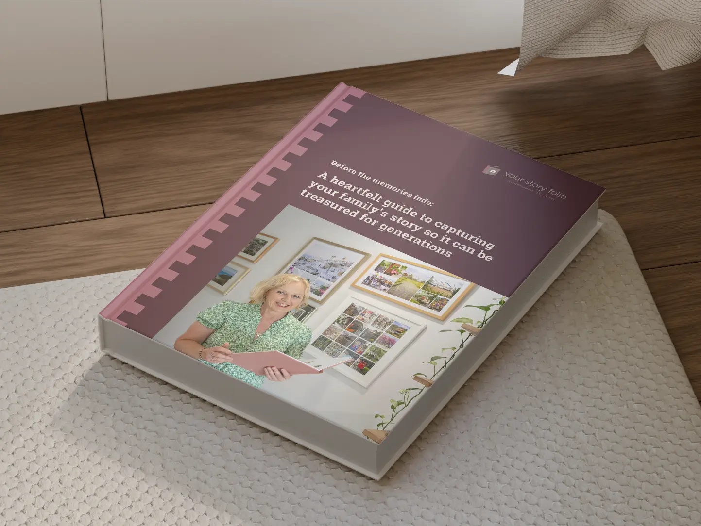 Book titled 'Before the memories fade: A heartfelt guide to capturing your family's story so it can be treasured for generations' with a photo of a smiling woman in a green dress holding a pink book, against a background of picture frames and a plant.