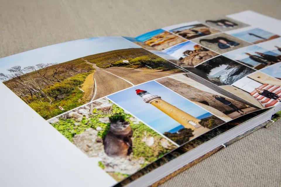 Open photo album displaying a collage of travel photos including a winding road, a lighthouse with a red top, a small animal, and various outdoor and portrait shots.