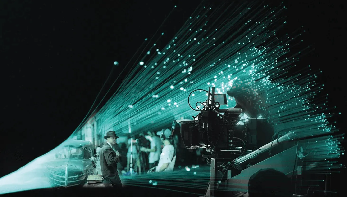 Camera in front of a partially lit green movie screen with 1930s movie on it