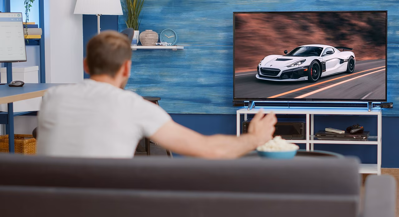 Image of a man watching a rapi electric car content on an IPTV/OTT platform by UniqCast