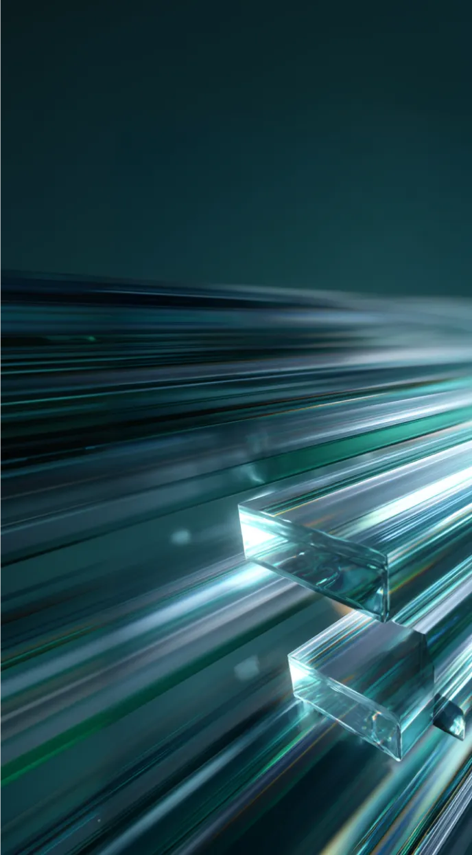 Close-up of elongated, transparent glass-like rectangular prisms with light streaks on a dark background.