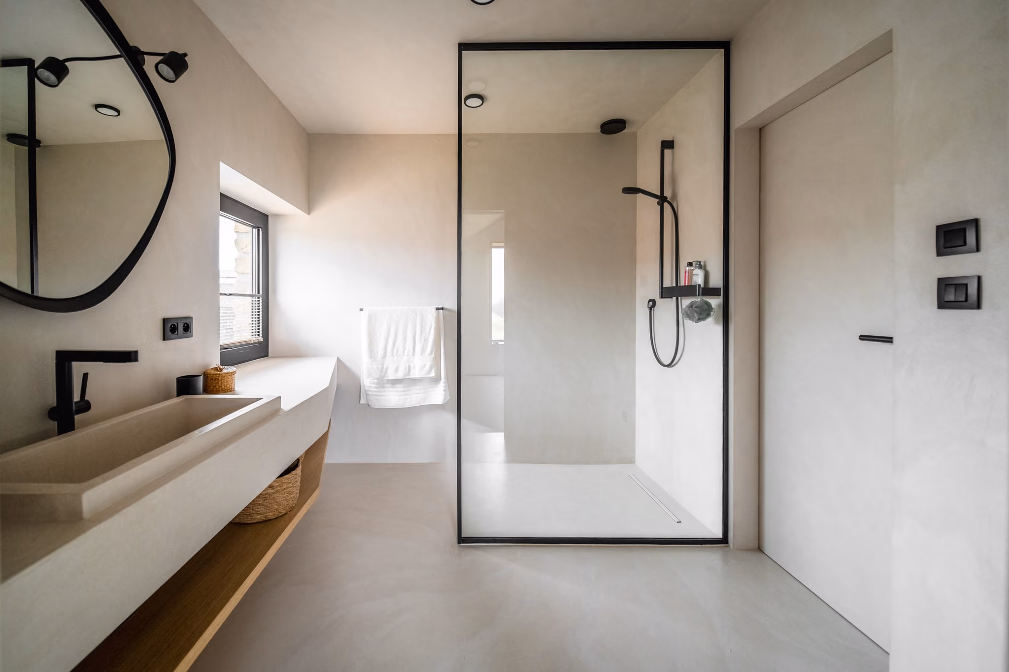 Salle de bain parentale sur mesure en béton ciré intégral et chêne à Fouche