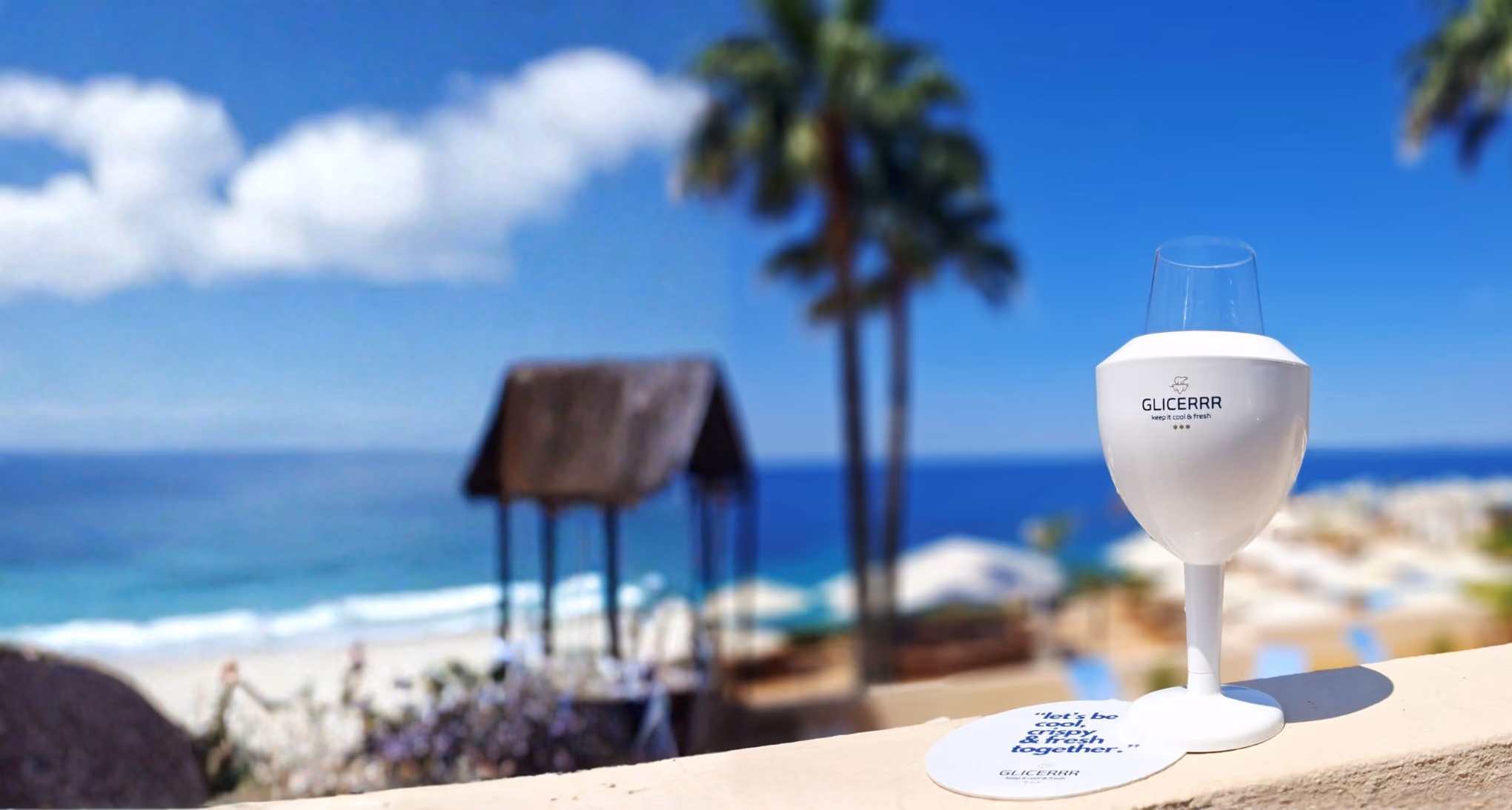 A GLICERRR wineglass cooler on the beach