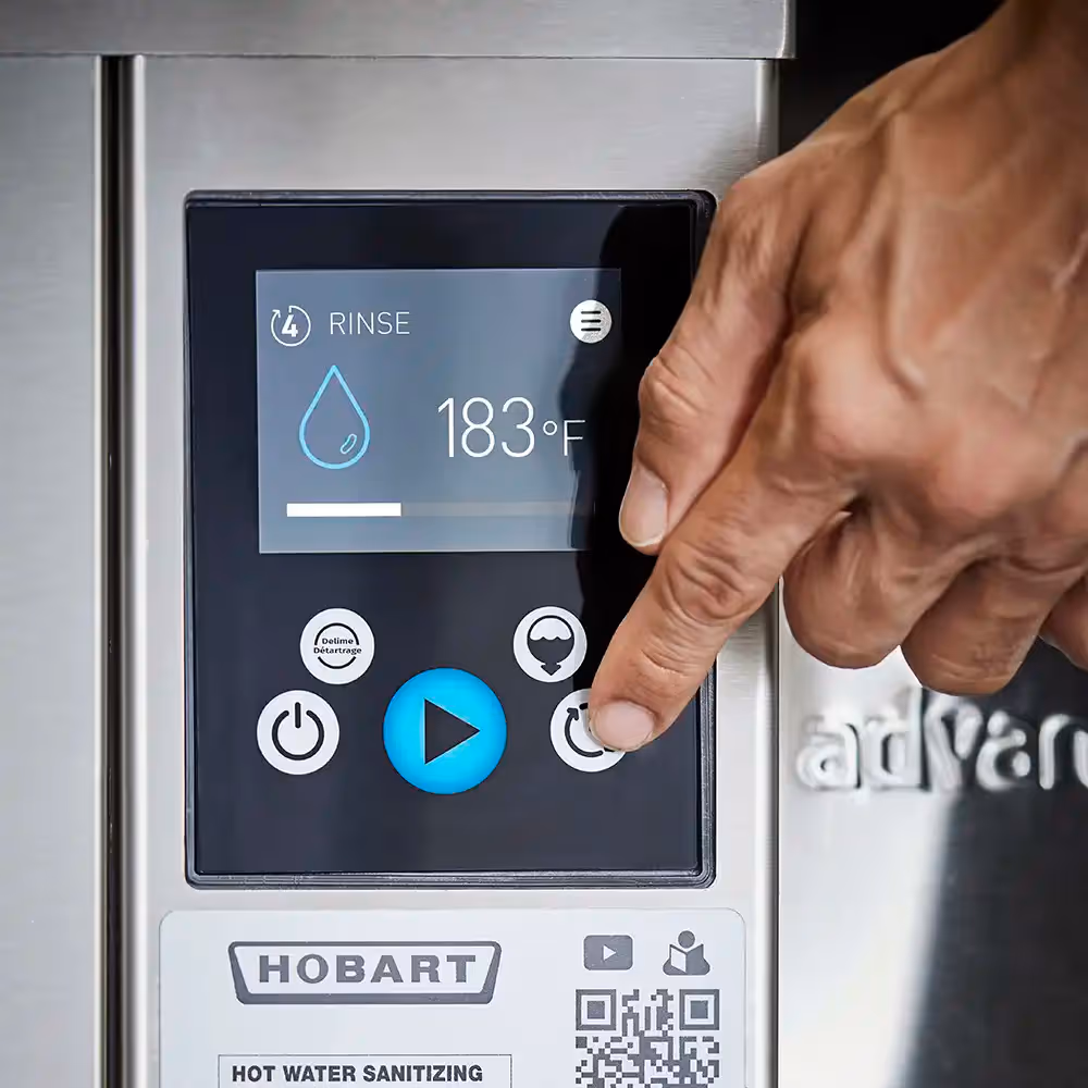 Hand pressing a button on a Hobart hot water sanitizing machine display showing rinse cycle at 183°F.