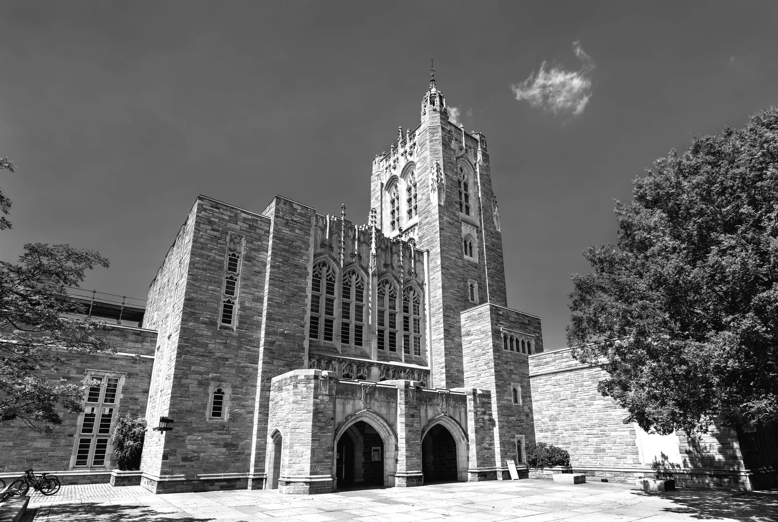 Black-and-white photo of a Gothic-style stone university building, the kind of institution that can sponsor cap-exempt H-1B visas