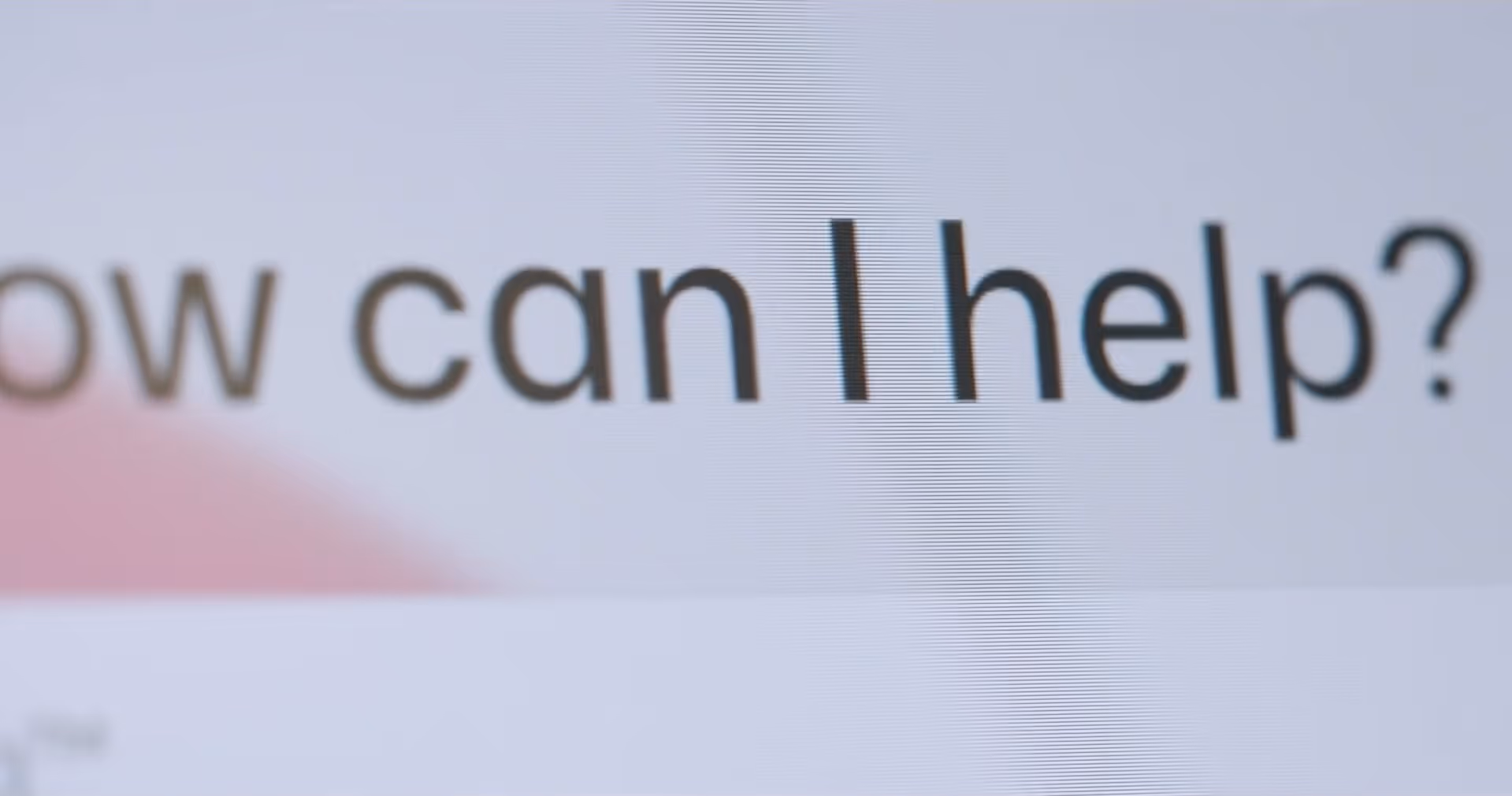 Close-up of text on screen reading 'How can I help?'