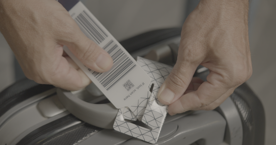 A bag tag attached to the suitcase b y the customer agent.