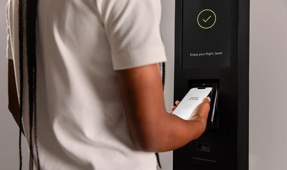 Passenger completing a touchless payment at an airport retail point