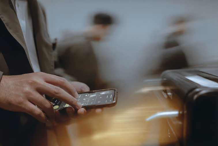 Airport agent using a mobile device for passenger check-in, illustrating the shift to mobile-enabled DCS