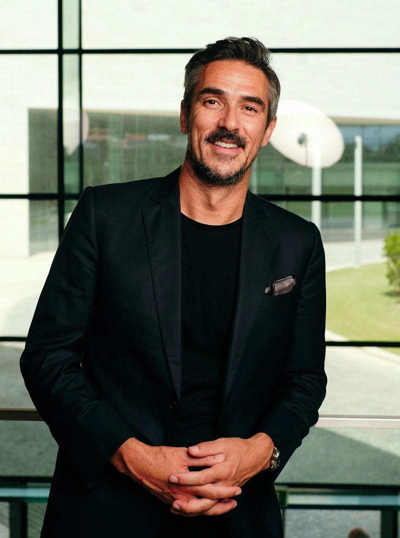 Miguel Stanley portrait - smiling in black suit 