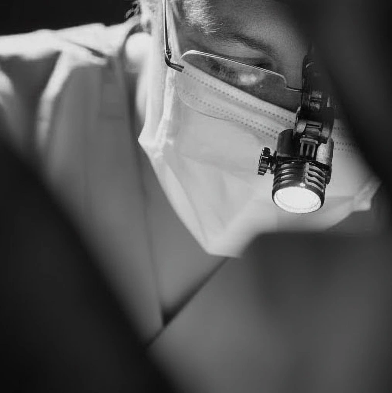 black and white photo of a working dentist closeup