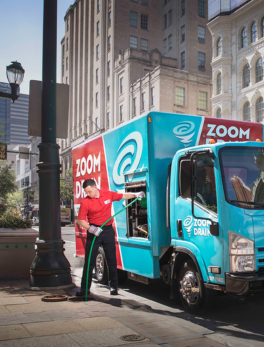 Zoom Drain truck parked outside with equipment ready for use.