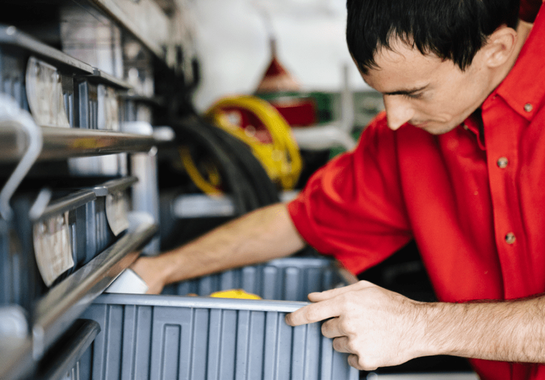 Technician inspecting and adjusting sewer line equipment.
