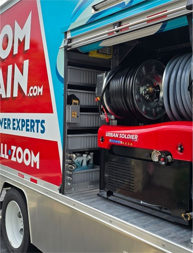 Plumbing equipment neatly organized inside a Zoom Drain service truck.