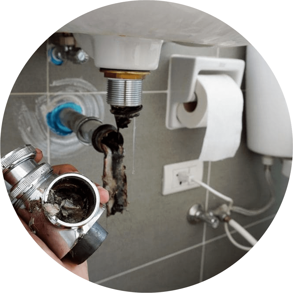 Under-sink plumbing installation showing pipes and fittings.