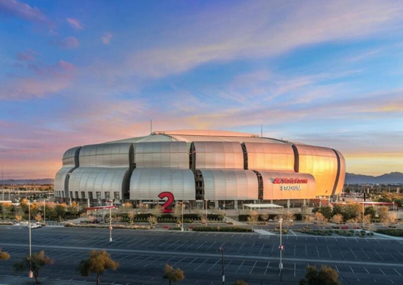 Circular view of a large modern sports stadium at sunset.