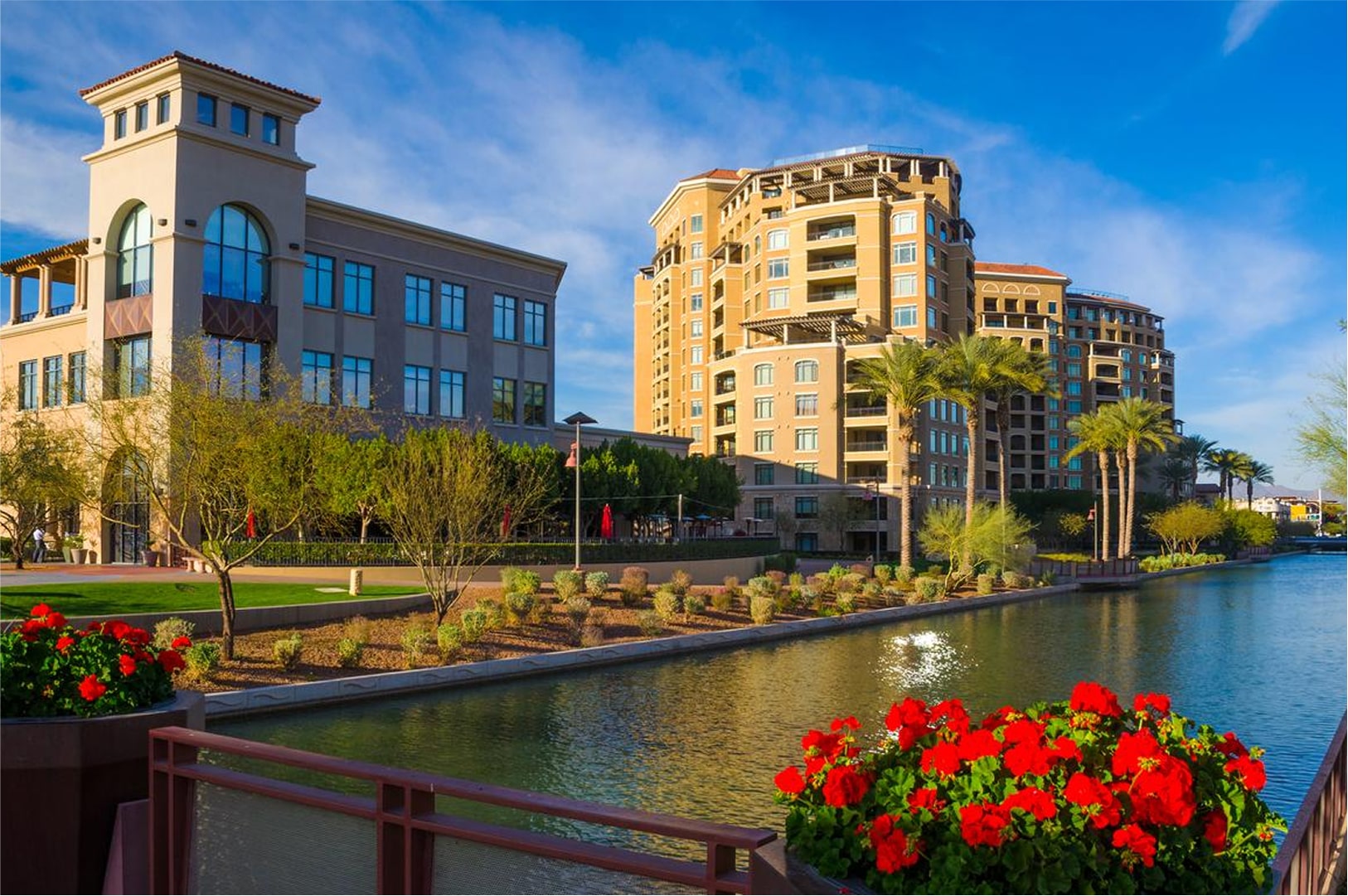 Waterfront buildings with flowers along the edge of a canal in Scottsdale.