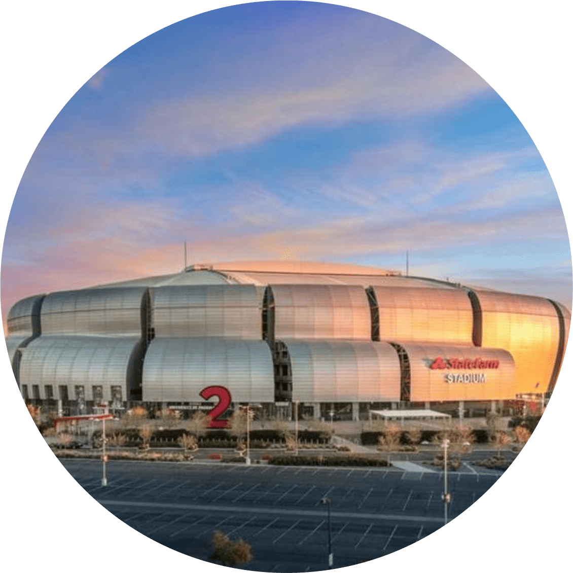 Circular view of a large modern sports stadium at sunset.