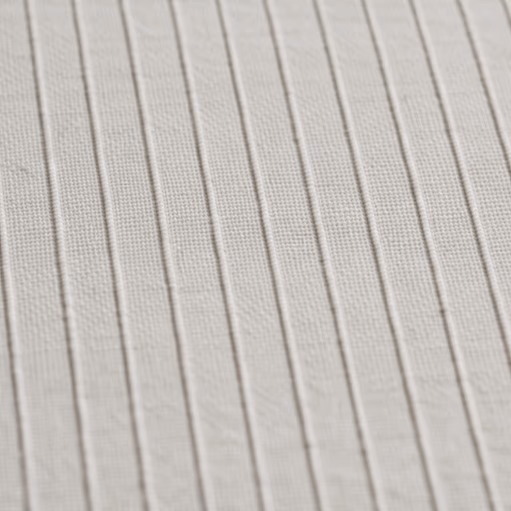 Close-up of textured fabric with vertical raised stripes.