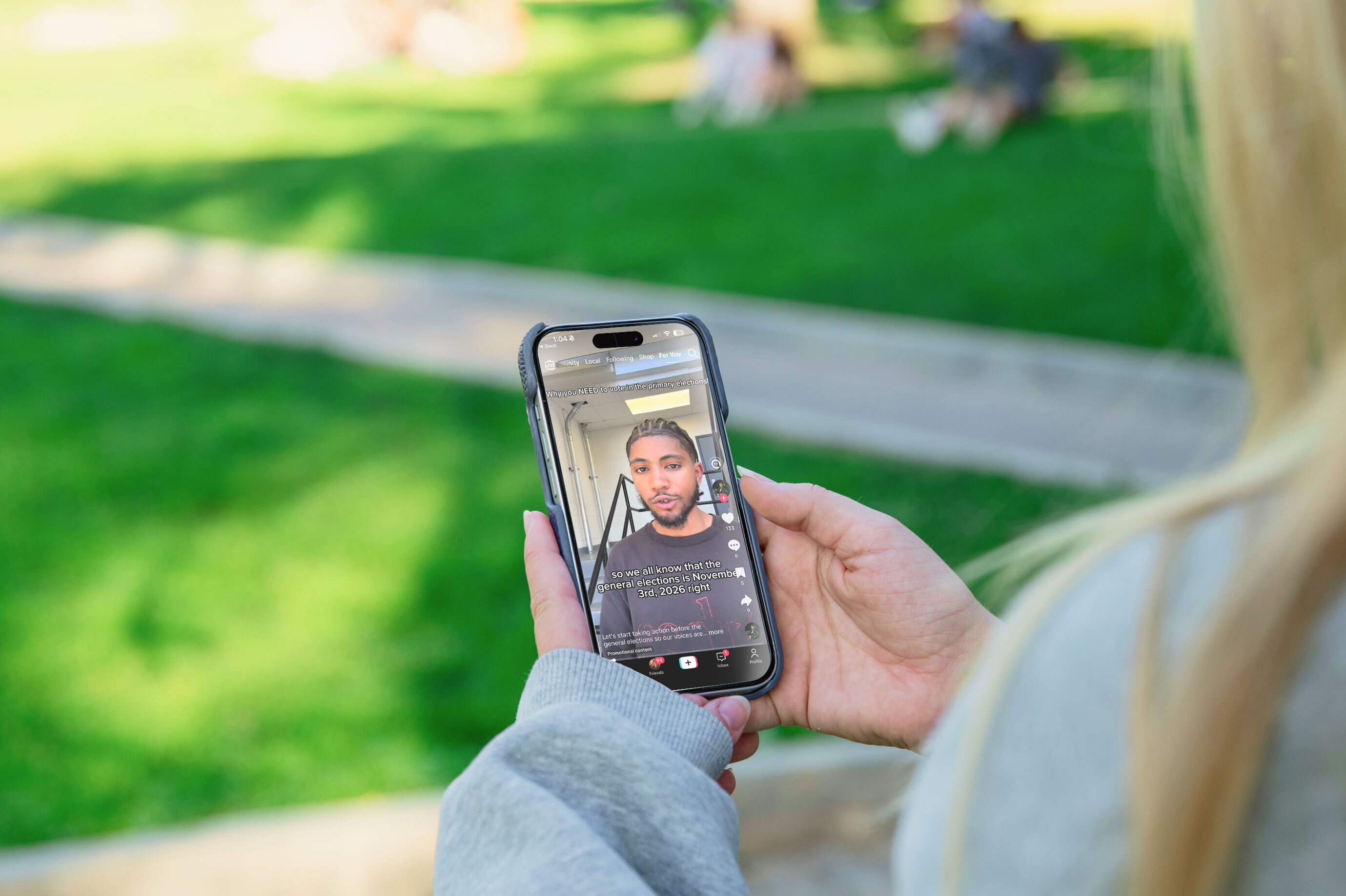 A female student views influencer content on her cell phone.