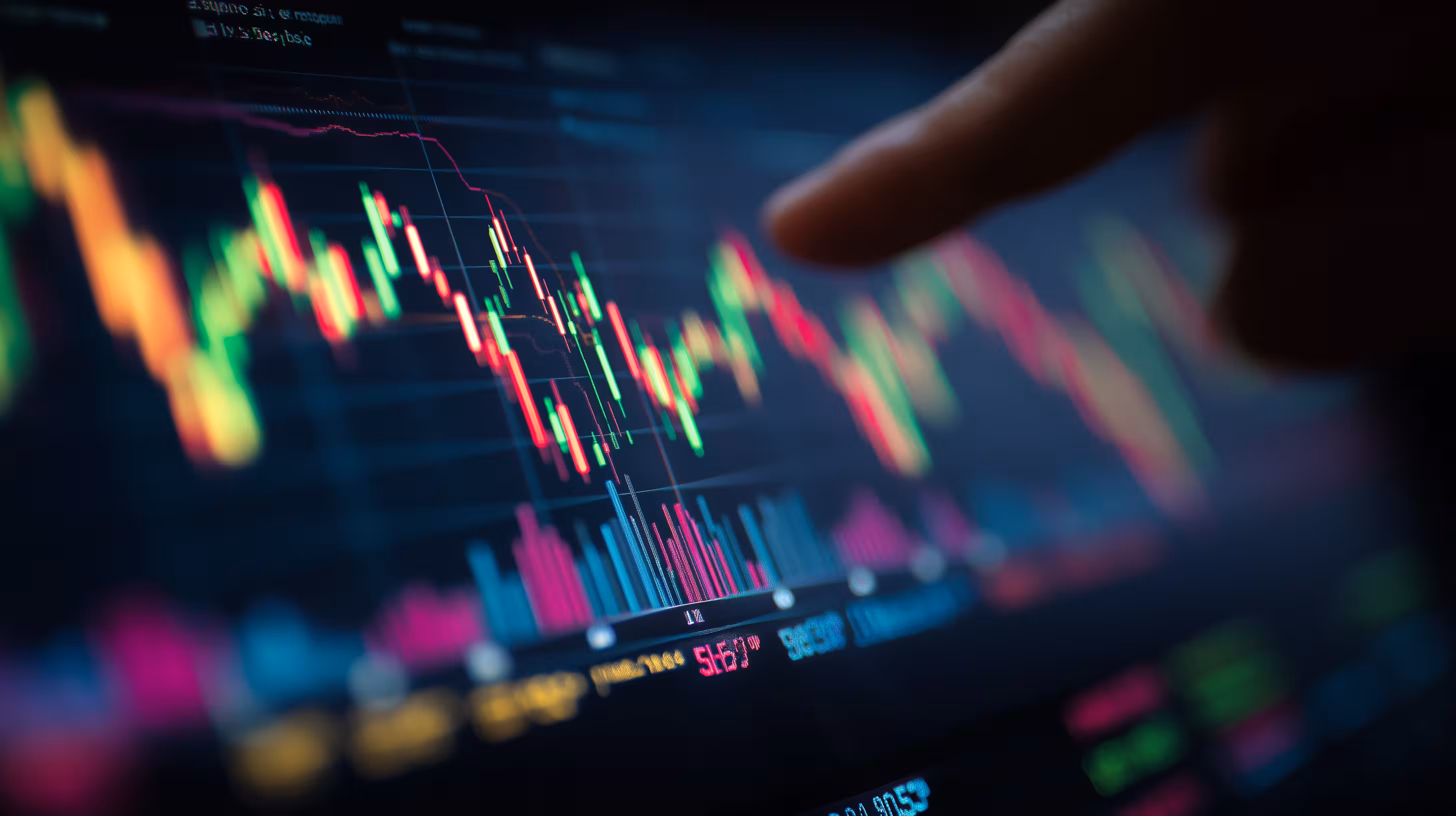 Close-up of digital trading screen displaying colorful candlestick charts and bar graphs with a finger pointing at the screen.