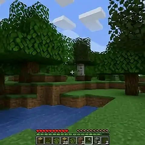 Minecraft game scene showing a pixelated forest with trees, grass, water, and a player's inventory bar at the bottom.