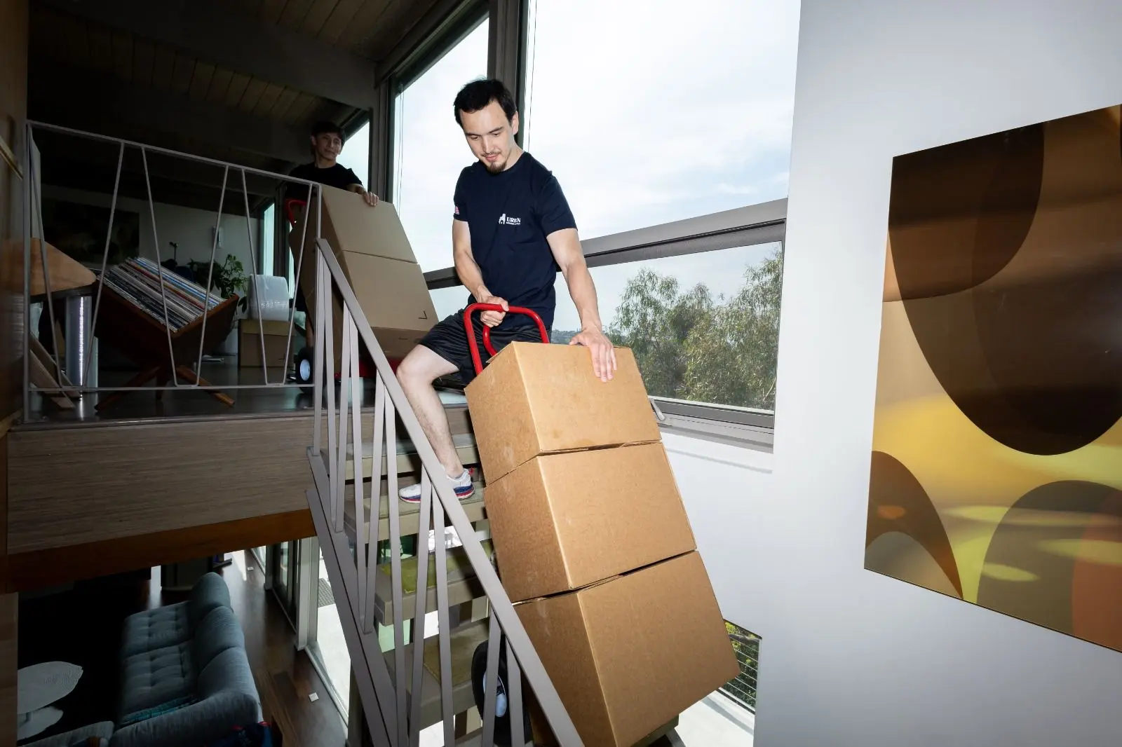 Movers stacking moving boxes during relocation in Los Angeles