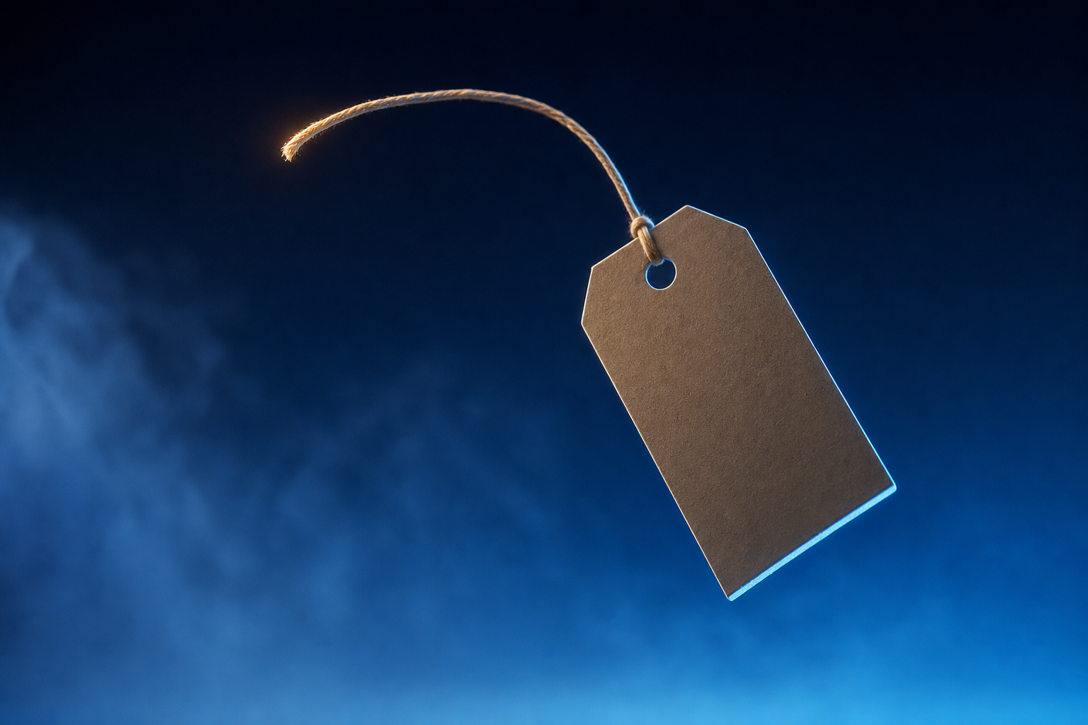 Price tag on a severed string drifting weightlessly, representing detachment from a fixed valuation.