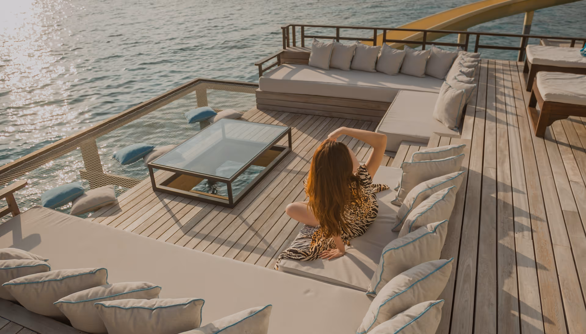 Woman relaxing on a luxury yacht deck at sunset — Moveolux private leisure travel and bespoke holiday experiences.