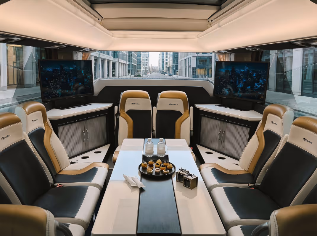 Luxury bus interior with leather seats, refreshments and screens — Moveolux luxury bus travel by land.