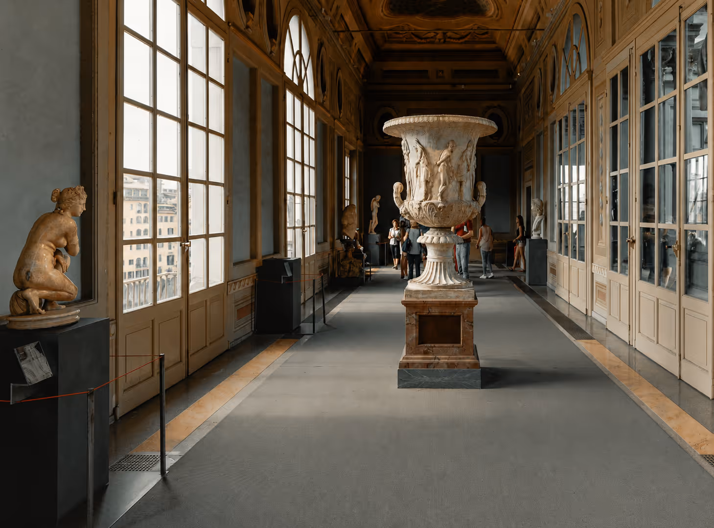 Guests in a classical sculpture gallery — private cultural experience arranged by Moveolux luxury concierge service in Italy.