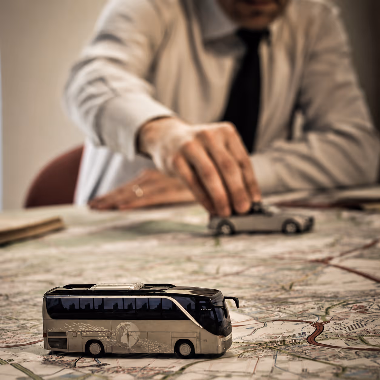 Hands planning a custom travel route on a map — luxury itinerary structure curated by Moveolux concierge service.