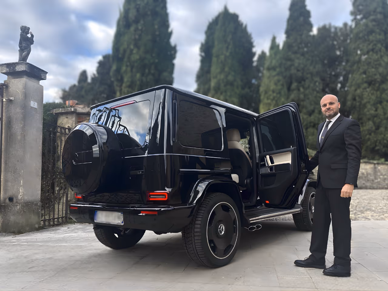 Moveolux chauffeur with a Mercedes G63 AMG luxury SUV — bespoke chauffeur-driven travel service.