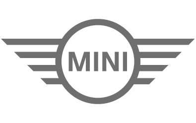 MINI brand logo featuring a black circle with the word 'MINI' in the center and gray wings extending horizontally from both sides.