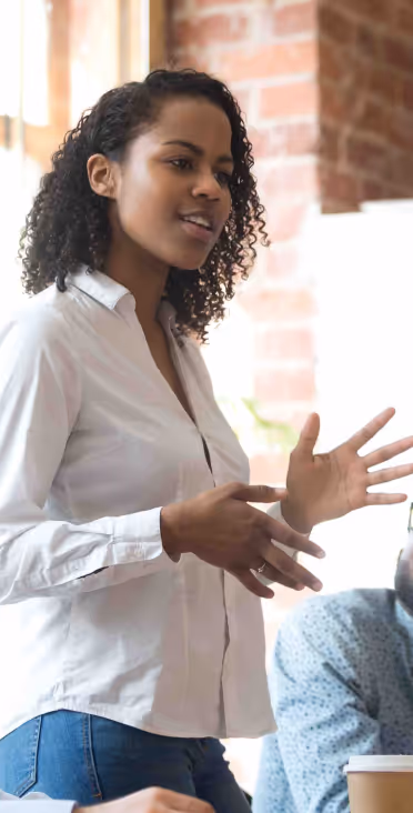 A woman in a white shirt engaged in a professional discussion or presentation