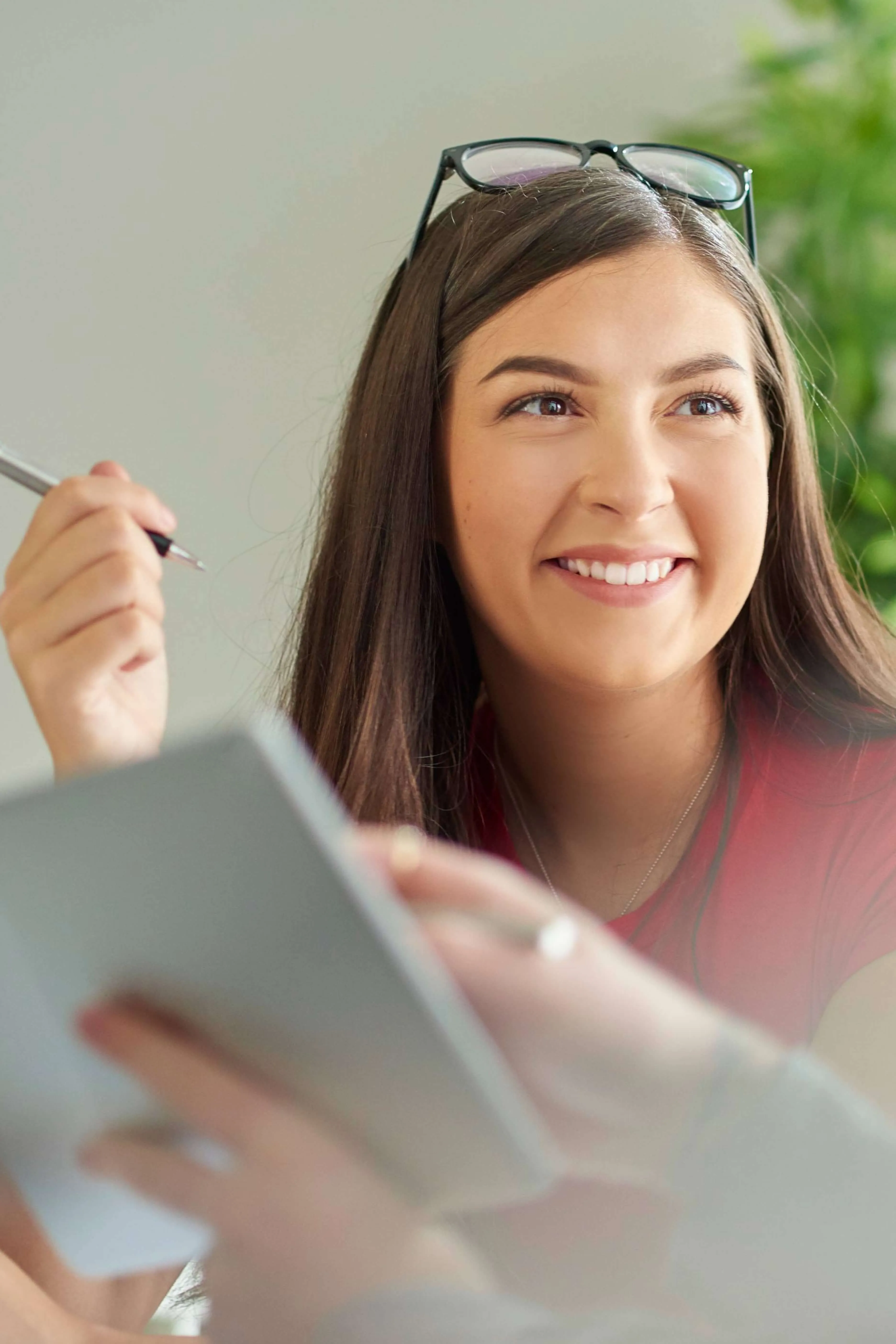Smiling young woman holding a tablet in a professional learning environment