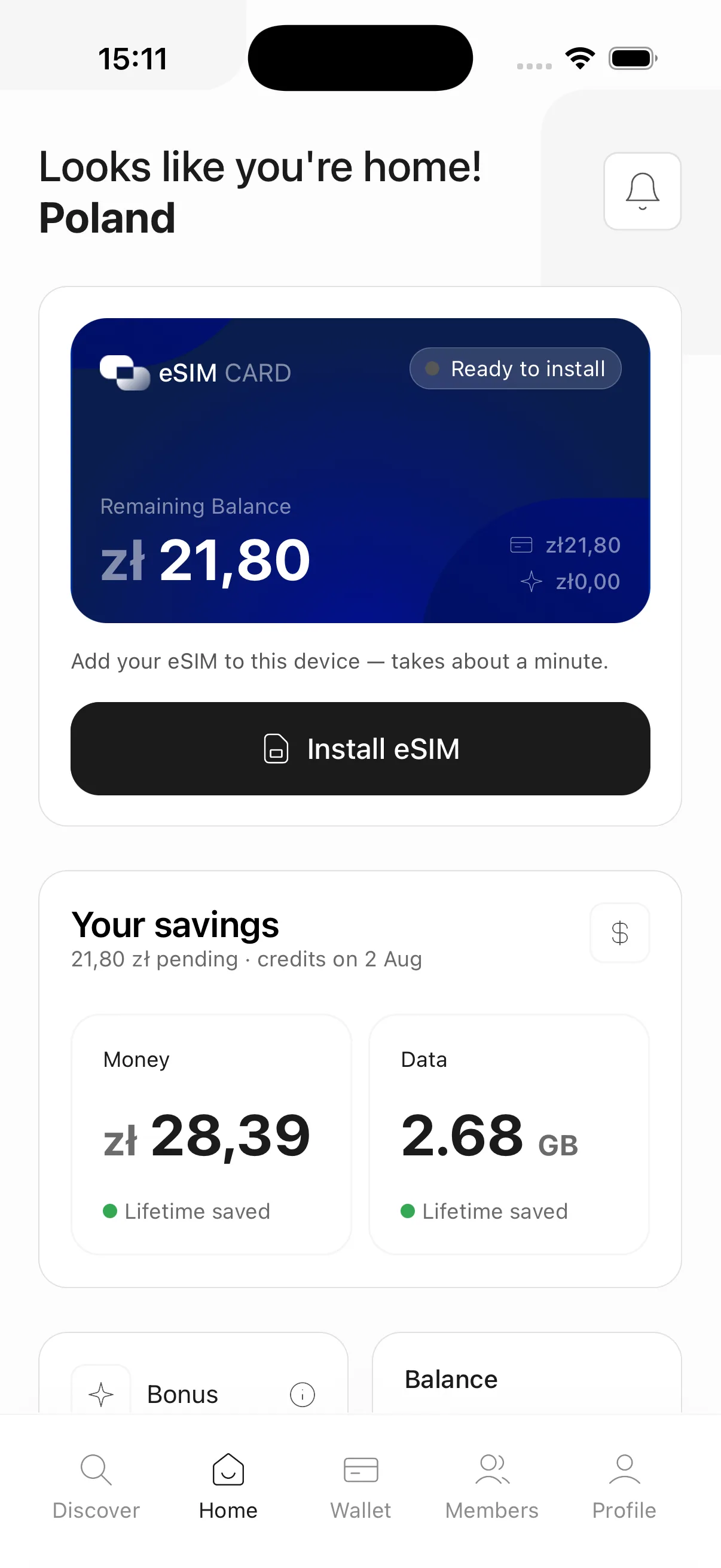 The traveler's home screen: a live eSIM card, remaining balance in local currency, and lifetime savings on money and data