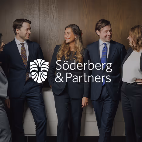 Four colleagues in formal business attire smiling and conversing against a wooden wall with Söderberg & Partners logo overlay.