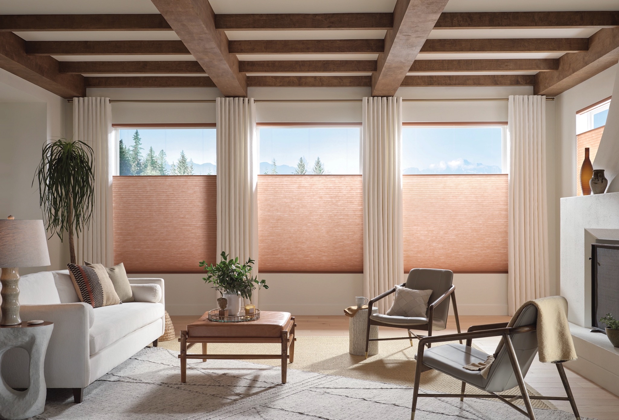 Terracotta cellular shades paired with ivory drapery panels in a beamed living room