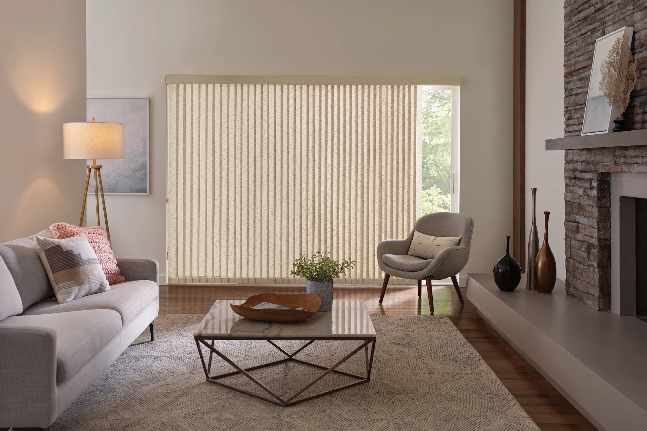 Cream fabric vertical blinds covering a wide sliding glass door in a living room
